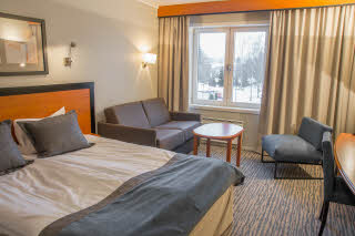 Double bed and sofa in room