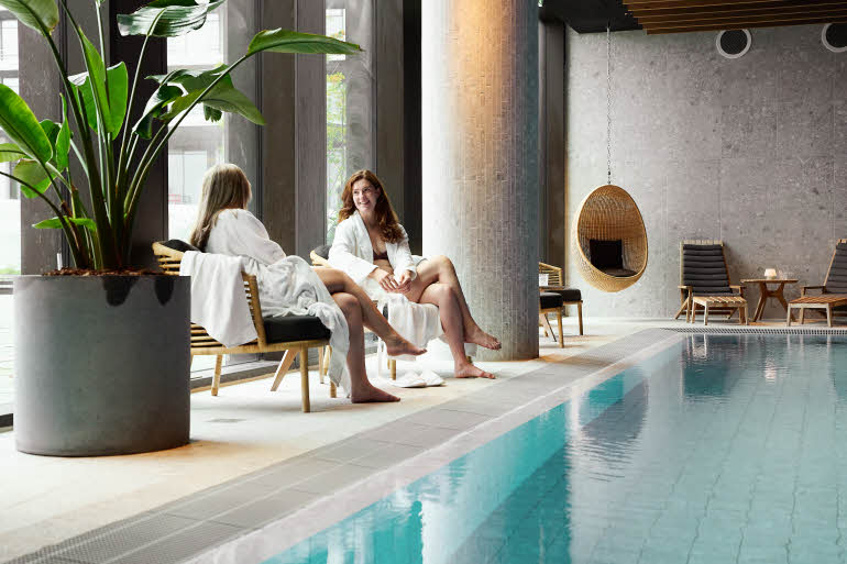 Two women beside the wellness pool