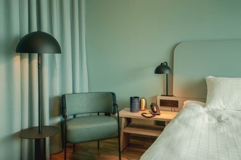 Chair and nights stand in superior room at scandic landvetter in gothenburg