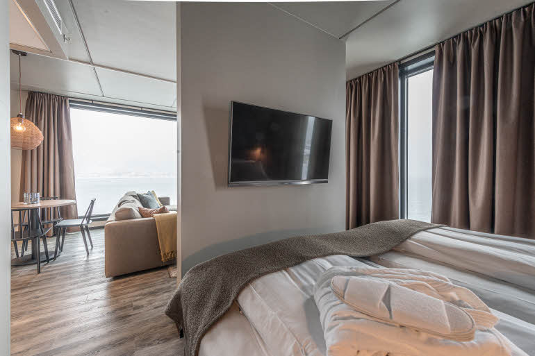 bed and tv in master suite at scandic sortland