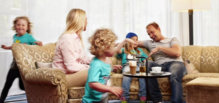 Family with kids playing in the hotel lobby